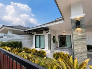 a home with a fence and landscaping at บ้านแสนสุข Hun Hin in Hua Hin