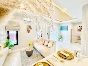 a living room with a couch and a table at บ้านแสนสุข Hun Hin in Hua Hin
