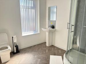 a bathroom with a sink and a shower at Seaside Apartments Redcar in Redcar