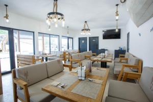 a restaurant with tables and chairs and windows at Danube Delta Bungalows Gorgova in Gorgova
