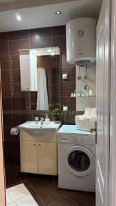 a kitchen with a washing machine and a sink at Grand Apartments Scepanovic in Tivat +60 photos