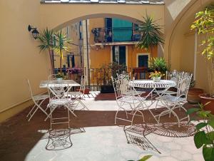 a patio with tables and chairs in a courtyard at Al Castello Residenza D'Epoca in Pietra Ligure