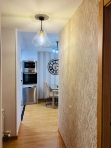 a kitchen and dining room with a table and a clock at Maresia in Burela de Cabo