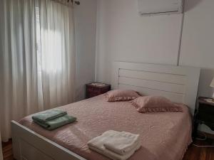 a bedroom with a bed with two towels on it at Casa do Cabeço in Proença-a-Nova +14 photos