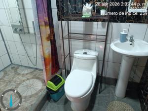 a bathroom with a toilet and a sink at Sloth House Rio Celeste in Rio Celeste +18 photos