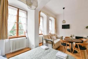 a living room with a bed and a table at TINY HOUSE Old Town in Prague