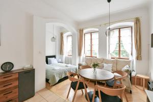 a living room with a table and a bedroom at TINY HOUSE Old Town in Prague