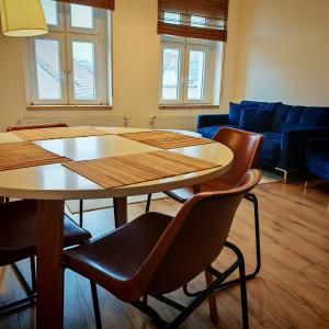 a living room with a table and chairs and a couch at Bramkowa 5 in Skorka