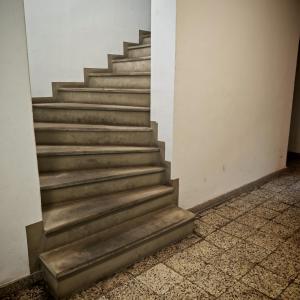 a set of stairs in a room with a tile floor at Bramkowa 5 in Skorka
