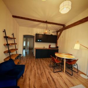 a living room with a table and chairs and a kitchen at Bramkowa 5 in Skorka