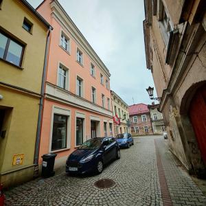 a car parked on a street next to buildings at Bramkowa 5 in Skorka