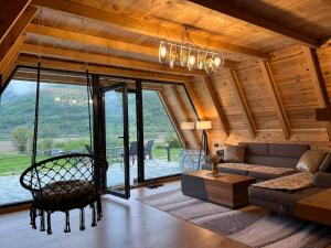 a living room with a couch and a table at LakeSideCottage in Plav