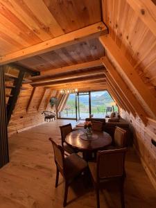 a dining room with a wooden table and chairs at LakeSideCottage in Plav