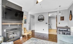 a living room with a fireplace and a flat screen tv at Uptown Gatlinburg in Gatlinburg