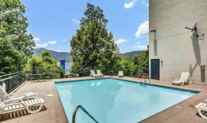 a large swimming pool with chairs at Uptown Gatlinburg in Gatlinburg