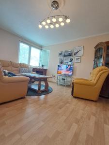 a living room with two couches and a table at Apartman Ajla in Bihać