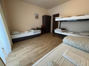a room with two bunk beds and a wooden floor at Air AMBER PEN LOTNISKO parking in Kaszów