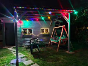 a house with a pergola at night with lights at CHAMBRES chez nous Sorties A62 6 ou 6 1 in Saint-Laurent