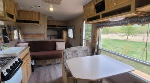 a kitchen and living room of a caravan at RV with Rocky Mountains View in McBride
