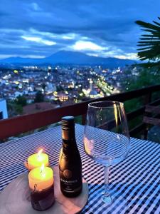 a bottle of wine and a glass on a table at Hotel Berati in Prizren +9 photos
