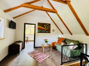 a living room with a couch and a table at Green Hills - Holiday Home & Events in Kamenica