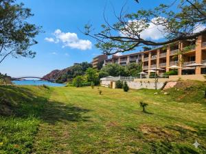 a building on a hill next to a body of water at Le Marina in Porto Ota