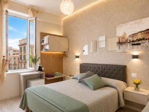 a bedroom with a bed and a large window at Il Quadrifoglio guesthouse in La Spezia