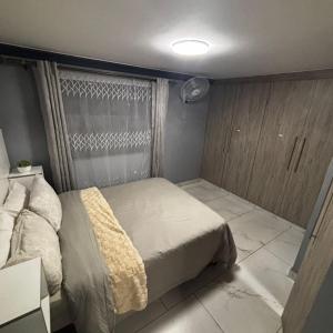 a small bedroom with a bed and a window at BEREA apartment 786 in Durban +23 photos