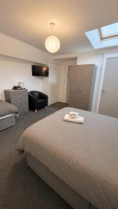 a bedroom with a large bed and a window at Apex Rooms Salford - Free Parking in Manchester