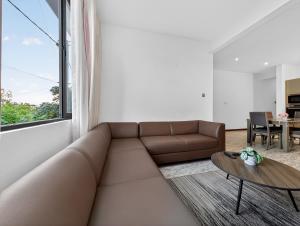 a living room with a couch and a table at Spacious Pereybere 3BR Apartment in Grand-Baie +3 photos