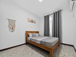 a bedroom with a bed and a window at Spacious Pereybere 3BR Apartment in Grand-Baie