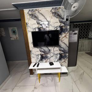 a marble wall with a tv and a table at BEREA apartment 786 in Durban
