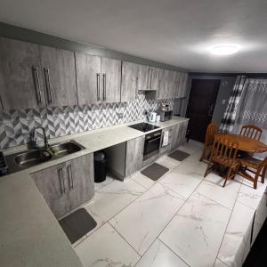 a kitchen with a sink and a table in it at BEREA apartment 786 in Durban