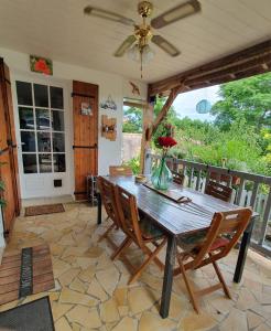 a dining room with a wooden table and chairs at CHAMBRES chez nous Sorties A62 6 ou 6 1 in Saint-Laurent