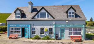 a building with two benches in front of it at Tigh an Trá in Bantry