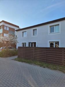 a wooden fence in front of a building at Melnragė in Melnragė