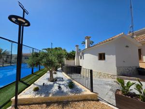 a villa with a swimming pool and a house at La Petite Finca in Elche