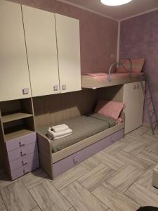 a small bedroom with a bunk bed and cabinets at Alloggio Acqui in Acqui Terme +14 photos