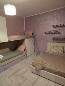 a bedroom with two bunk beds and a ladder at Alloggio Acqui in Acqui Terme