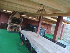 a long table in a room with a fireplace at Cabana Bianca & Iair in Poiana Vadului