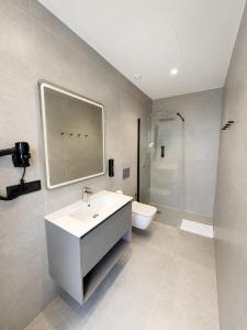 a bathroom with a sink and a toilet at OMO STAYS Pinada Park in Guardamar del Segura +21 photos
