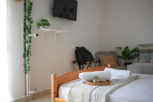 a bedroom with a bed with a laptop on it at Boho Center Studio in Keramoti