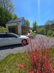 a car parked in front of a tiny house at Nad Strumieniem in Pieszyce +46 photos