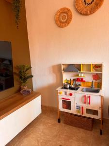 a toy kitchen with a pretend stove in a room at Casa Midu Beachhouse 450m to the Beach in Los Alcázares +36 photos