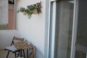 a table and a chair next to a window at Boho Center Studio in Keramoti
