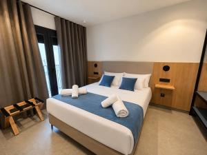 a bedroom with a large bed with blue and white pillows at OMO STAYS Pinada Park in Guardamar del Segura