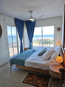 a bedroom with a bed with a view of the ocean at Villa Dérimbeault in Oyster Pond +25 photos