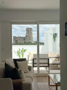 a living room with a view of a building at Casa Puerta del Valle in Belalcázar