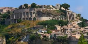 a view of the colosseum and houses on a hill at brezza marina in Siderno Marina