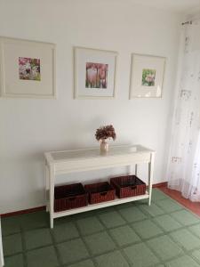 a room with a white table with baskets on it at Gemütliche Ferienwohnung in Philippsburg